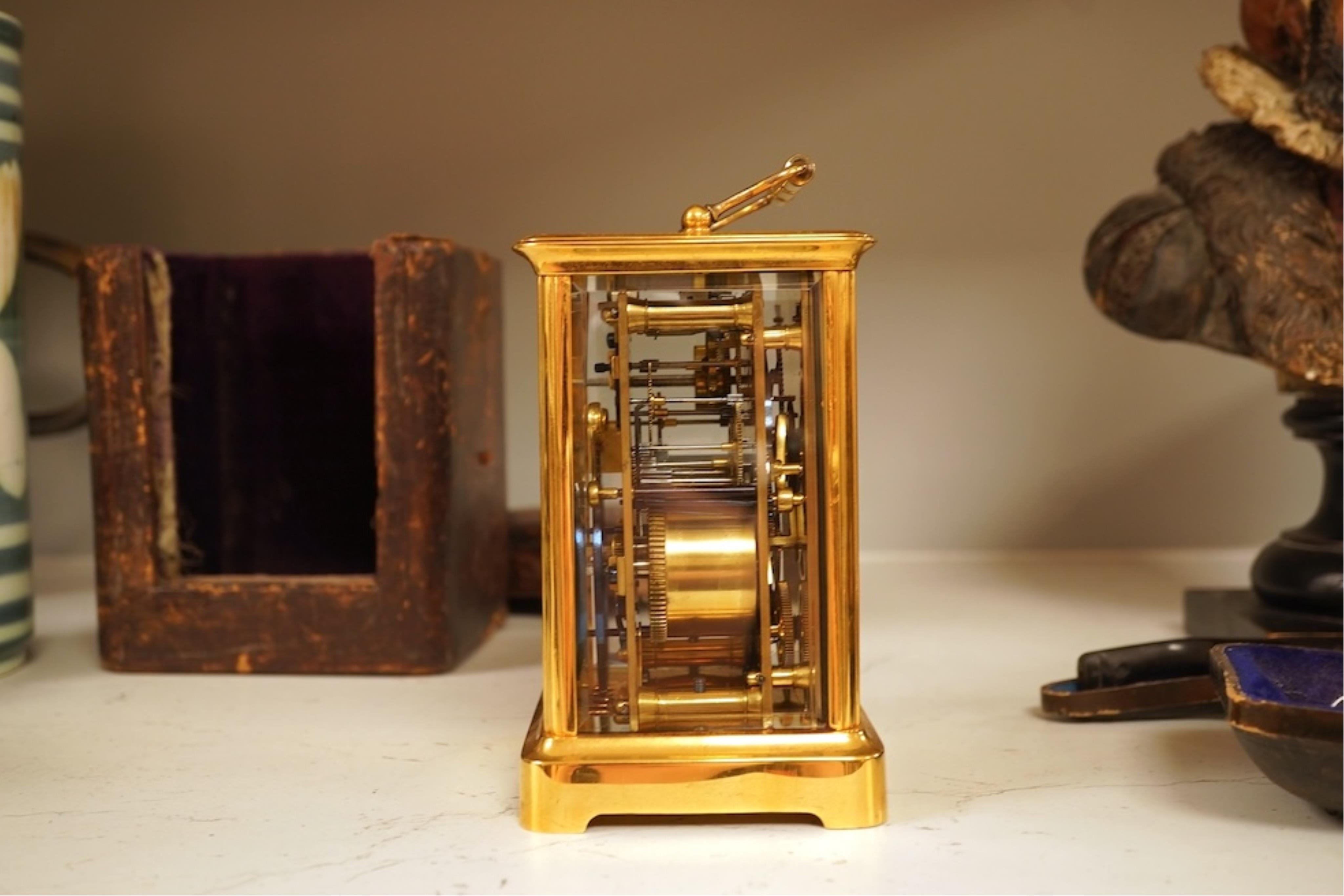 A French carriage clock with alarm, gong-striking movement, in a contemporary leather case, 17cm high